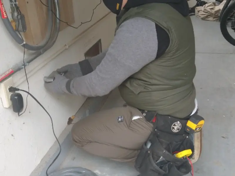 Electrician performing outlet wiring in a Rolling Meadows garage